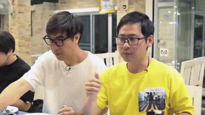 Two Men Sitting At Table With 52 Sign GIF