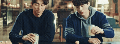 Two Men Sitting At Table With Beer And Eggs GIF