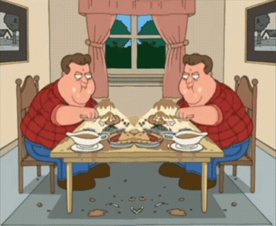 Two Men Sitting At Table With Food GIF