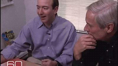 Two Men Sitting at Table With Gold Flake Chips