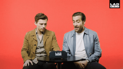 Two Men Sitting At Table With Lad Video Box GIF