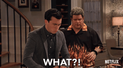 Two Men Sitting At Table With Netflix Logo GIF