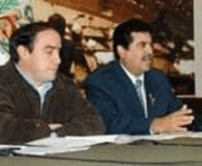 Two Men Sitting At Table With Papers GIF