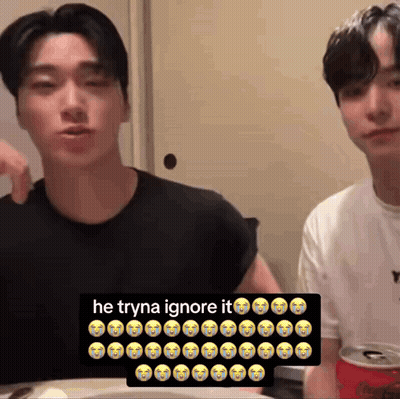 Two Men Sitting At Table With Soda Sign Saying He Tryna Ignore It GIF