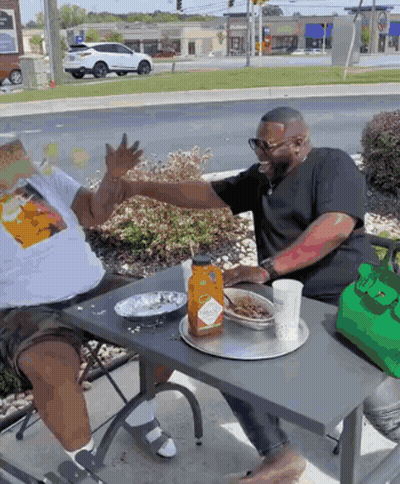 Two Men Sitting At Table With Tabasco Sauce GIF