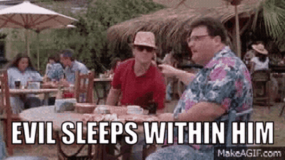 Two Men Sitting At Table With Umbrellas In Restaurant GIF