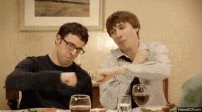 Two Men Sitting At Table With Wine And Food GIF
