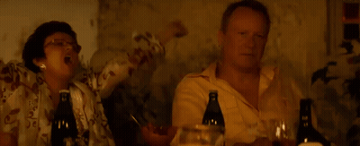 Two Men Sitting At Table With Wine GIF