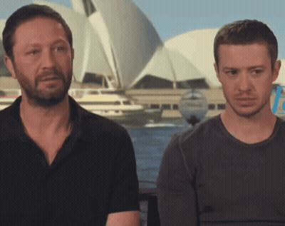 Two Men Sitting Beside Boat GIF