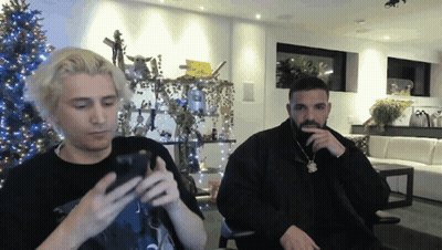 Two Men Sitting By Christmas Tree GIF