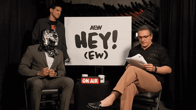 Two Men Sitting By Hey Sign GIF