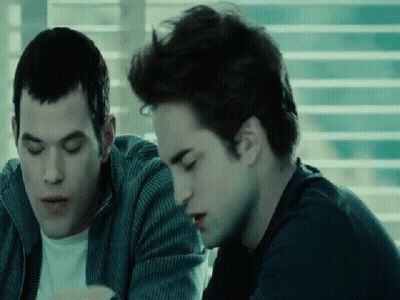 Two Men Sitting By Window Looking At Something GIF