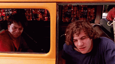 Two Men Sitting In Back Of Yellow Van Looking Out Window GIF