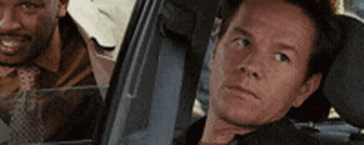 Two Men Sitting In Car Looking Out Window GIF