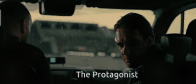 Two Men Sitting In Car With Word Protagonist GIF
