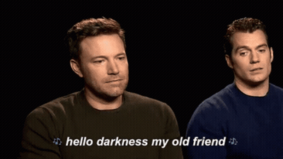 Two Men Sitting In Dark Room Saying Hello Darkness My Old Friend GIF