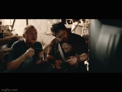 Two Men Sitting In Dark Room Talking GIF