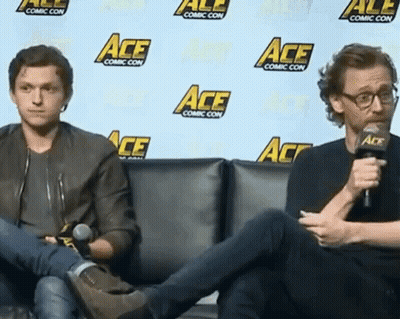 Two Men Sitting In Front Of Ace Wall GIF