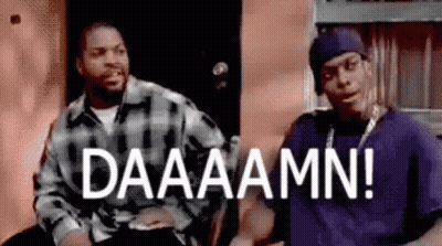 Two Men Sitting In Front Of Building Saying Daaaamm GIF