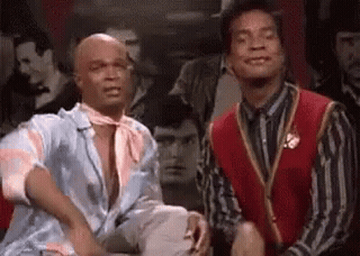 Two Men Sitting In Front Of Crowd GIF
