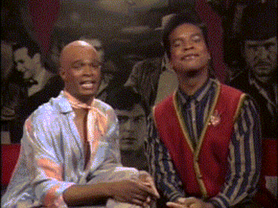 Two Men Sitting In Front Of Crowd GIF