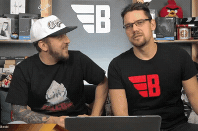 Two Men Sitting In Front Of EB Sign GIF