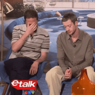 Two Men Sitting In Front Of Etalk Sign GIF