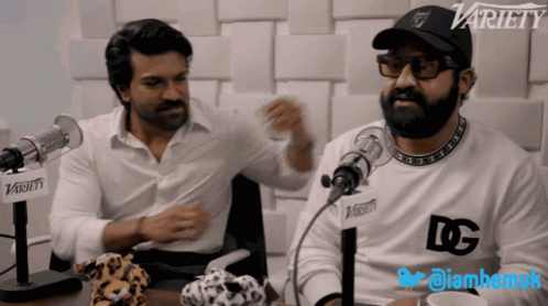 Two Men Sitting In Front Of Microphones GIF