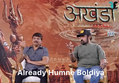Two Men Sitting In Front Of Poster Saying Already Humne Boldiya GIF