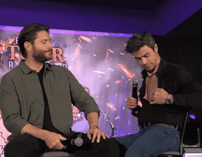 Two Men Sitting In Front Of Tor Sign GIF