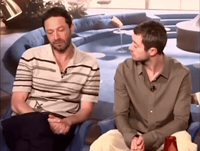 Two Men Sitting In Living Room Talking GIF