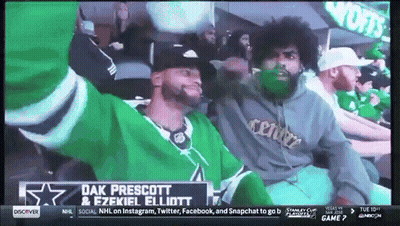 Two Men Sitting In Stadium With Dak Prescott & Ezekiel Elliott Sign GIF