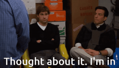 Two Men Sitting Near Moving Boxes And Sign GIF