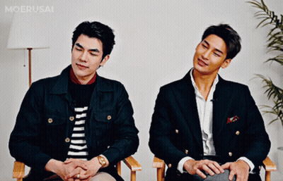 Two Men Sitting Next To Each Other GIF