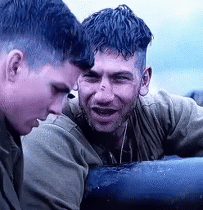 Two Men Sitting Next To Each Other On A Boat GIF