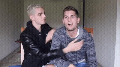 Two Men Sitting Next To Each Other One Wearing Abercrombie & Fitch Sweater GIF