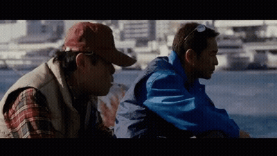 Two Men Sitting Next To Each Other GIF