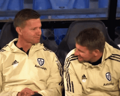 Two Men Sitting Next To Each Other Wearing Jackets That Say Astonish GIF