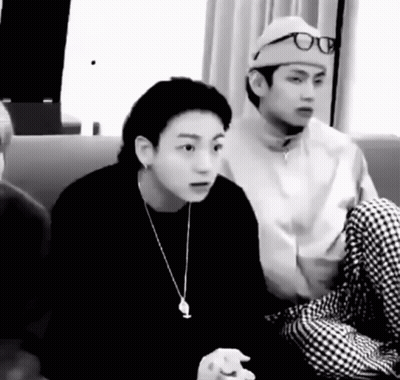 Two Men Sitting On A Couch One Wearing Hat And Glasses GIF