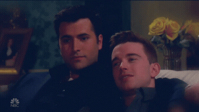 Two Men Sitting On A Couch With A Nbc Logo On The Bottom Right GIF
