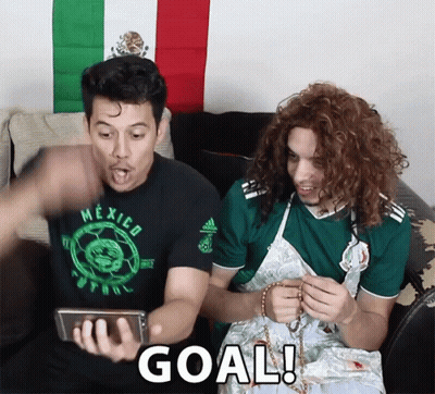 Two Men Sitting On A Couch With One Wearing A Mexico Shirt GIF