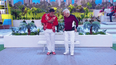 Two Men Sitting On Bench In Garden GIF