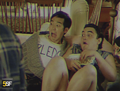 Two Men Sitting On Couch One In Pledge Shirt GIF