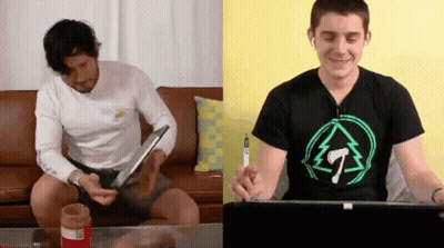 Two Men Sitting On Couch One Wearing T-Shirt GIF