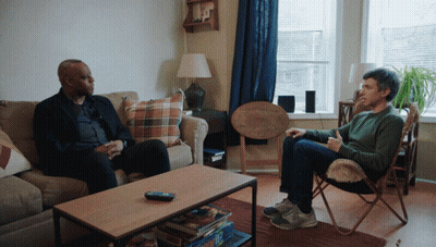 Two Men Sitting On Couch Talking GIF