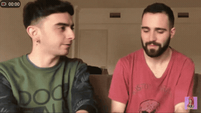 Two Men Sitting On Couch With Doo Shirt GIF