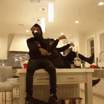 Two Men Sitting On Kitchen Counter GIF