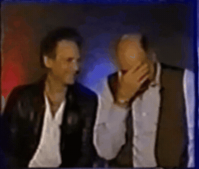 Two Men Sitting One Covering Mouth GIF