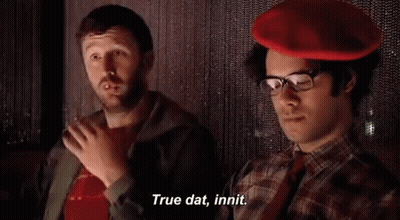 Two Men Sitting, One In Red Hat GIF