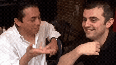 Two Men Sitting One Pointing At Other GIF